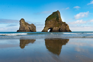 New Zealand wharariki beach and arch island rock formations - 189750615