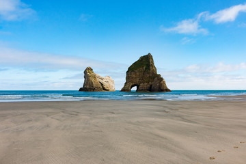 New Zealand wharariki beach and arch island rock formations - 189750685