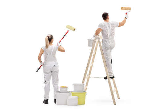 Female painter and a male painter climbed up a ladder painting