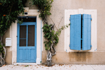 Old house with vivid blue door and shutters, Provence village, south France