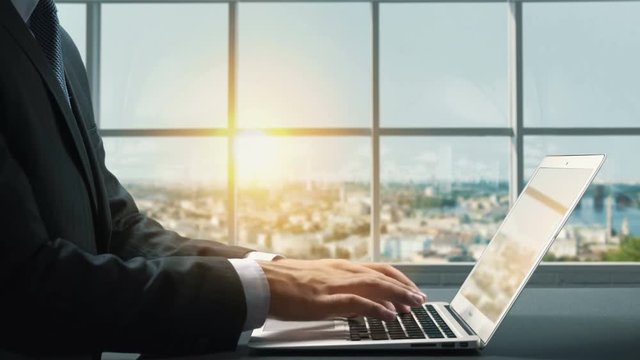 View of Podil Kiev Ukraine.Close up hand Businessman using laptop