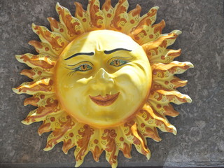 Handmade ceramic yellow symbolic sun of SICILY on wall in city center of TAORMINA