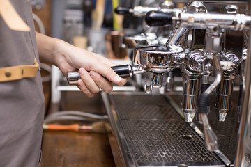 Hand of Barista making Coffee with coffee machine in the coffee shop. people with barista in cafe concept.