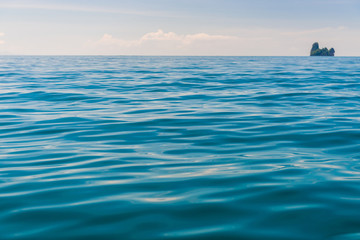 Fototapeta premium Andaman Sea, close-up water and an island on the horizon