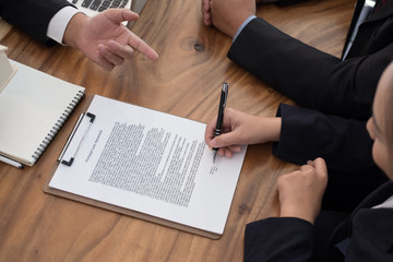 man applying for mortgage loan with bank employee. client signing contract document with realtor at real estate agency. property, finance & banking concept