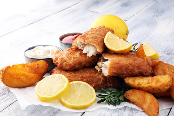 traditional British fish and chips with potato and lemon