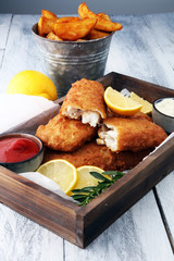 traditional British fish and chips with potato and lemon