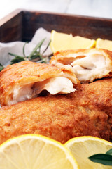 traditional British fish and chips with potato and lemon