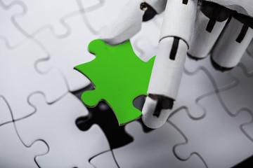 Robot Holding Green Jigsaw Puzzle