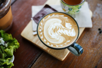 a cup of coffee on wood