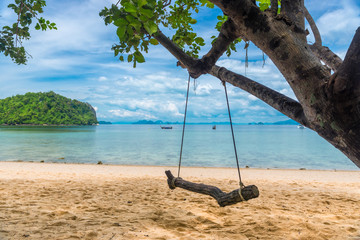 close-up of a swing on a tree on a sandy pyramid on the background of the sea, Thailand