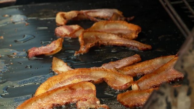 Cooking delicious bacon at food and BBQ festival