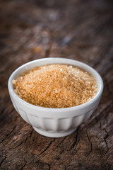 Brown sugar on wooden background