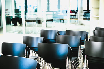 empty black chairs in meeting room