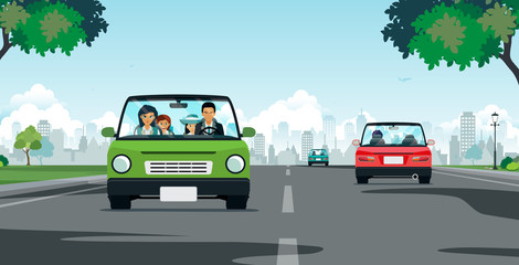 The family drove along the road with the city as the backdrop.