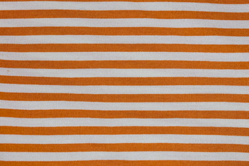 fabric in white and orange stripes, closeup on stitch