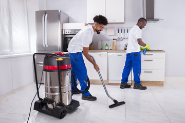 Two Male Janitor Cleaning The Kitchen