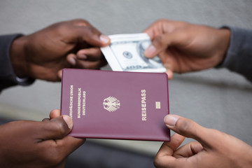 Hands Exchanging Passport For Banknote