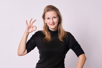 Fototapeta premium Young beautiful girl. White background. Gesture