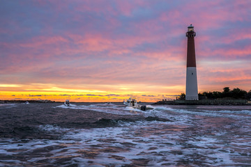 Fishing Boats By a Lighthouse at Sunrise