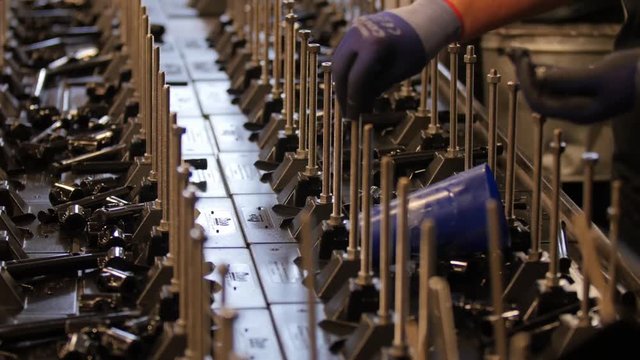 Workers putting together parts in an assembly line