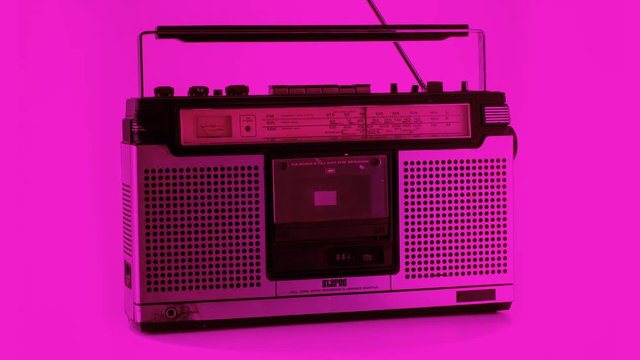 a selection of vintage ghettoblasters and radios spinning around. it is filmed in a way that the objects change as they rotate