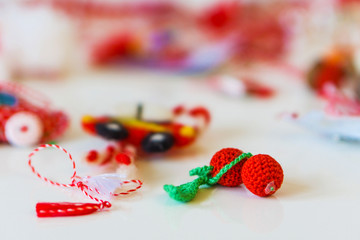 Close-up of handmade martenitsi made of natural materials. White and red threads, symbolizing health.
