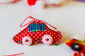 Close-up of handmade martenitsi made of natural materials. White and red threads, symbolizing health.