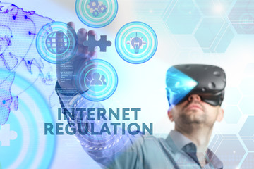 Business, Technology, Internet and network concept. Young businessman working in virtual reality glasses sees the inscription: Internet regulation
