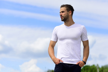 Macho wearing pants and white tshirt on clear sky background