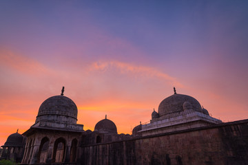 Mandu India, afghan ruins of islam kingdom, mosque monument and muslim tomb. Colorful sky at...