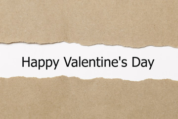The text Happy Valentine's Day word appearing behind torn paper