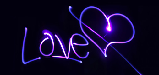 Neon heart and inscription Love on a dark background