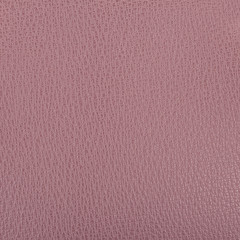A piece of intense lilac artificial leather texture closeup