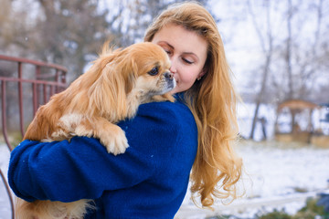 Nice young woman on a walk with her dog resting at park. Best friendship girl and senior dog. Psychology of dog owner 