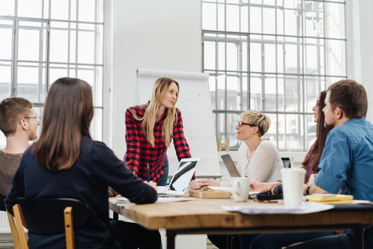 Young businesswoman lecturing to colleagues