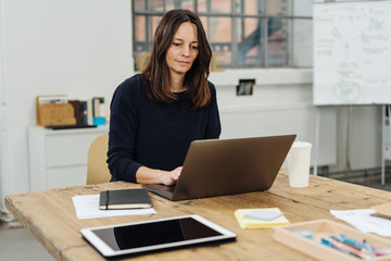Woman working with laptop in office