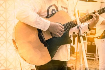Guitar / View of musician playing guitar in concert. Movement. Soft focus.