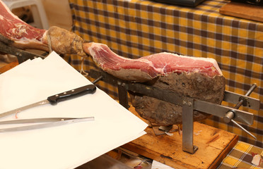 expensive raw ham in the deli for cutting by the butcher