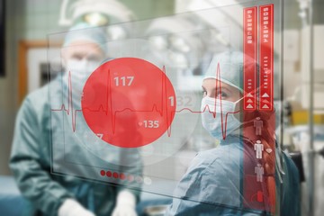 Surgeons checking holographic heart rate display