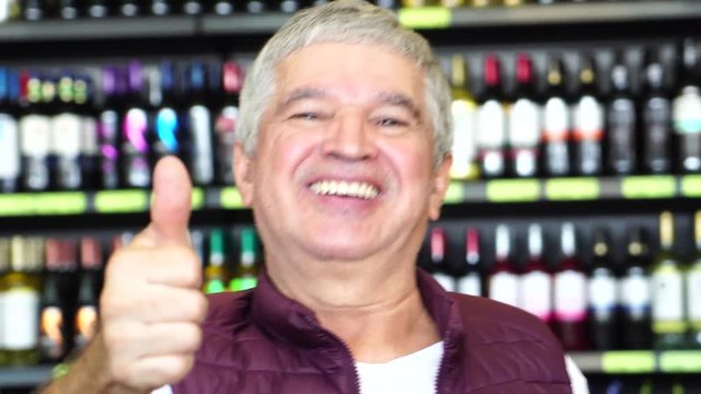 Satisfied Man Thumbs Up with Bottles on background
