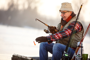 Fisherman fishing on river