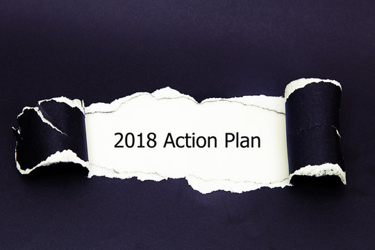 The text 2018 Action Plan appearing behind torn paper