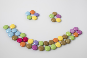 Smile candies in a white background composition