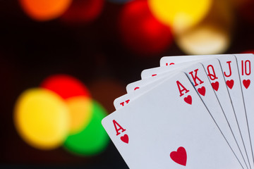 Royal flush poker cards combination on blurred background casino luck fortune card game
