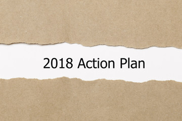 Fototapeta na wymiar The text 2018 Action Plan appearing behind torn paper