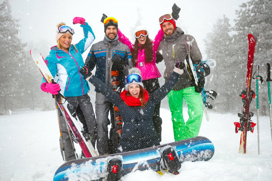 Group of smiling snowboarders having fun
