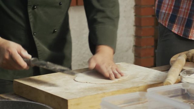 Chef is kneading a dough for frour Tortillas.