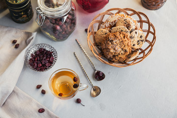 Hot herbal tea with a dogrose in a glass cup.