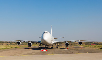 Fototapeta na wymiar white passenger airplane is on the to runway of airport